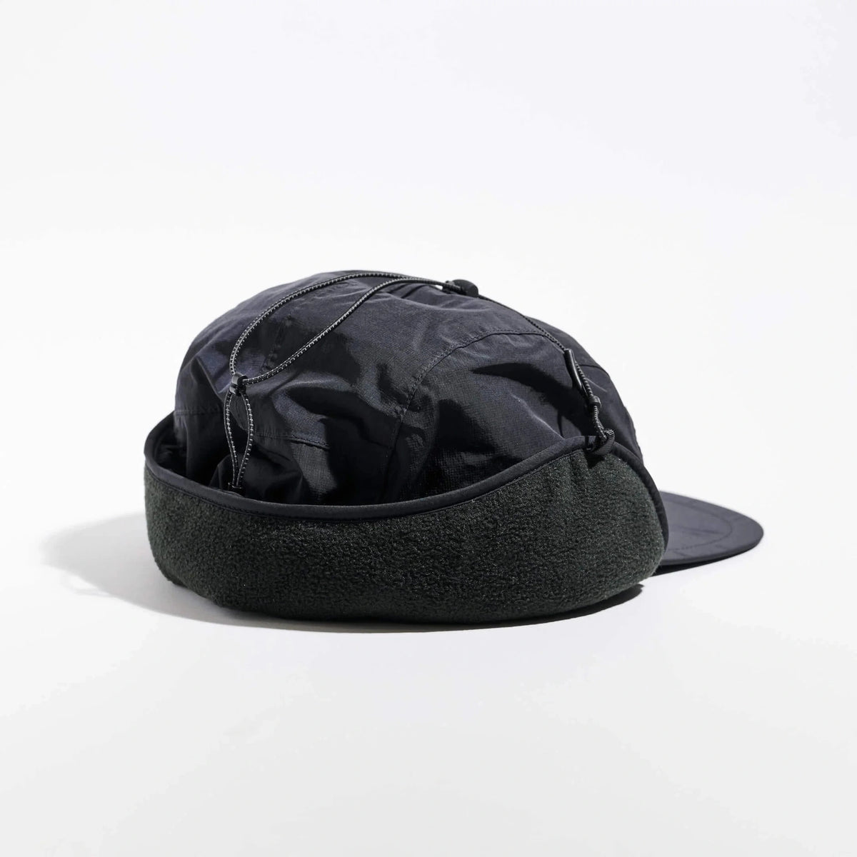 Vaga Padded Hiker Cap in black – rear angle view with fleece band and ear flaps up