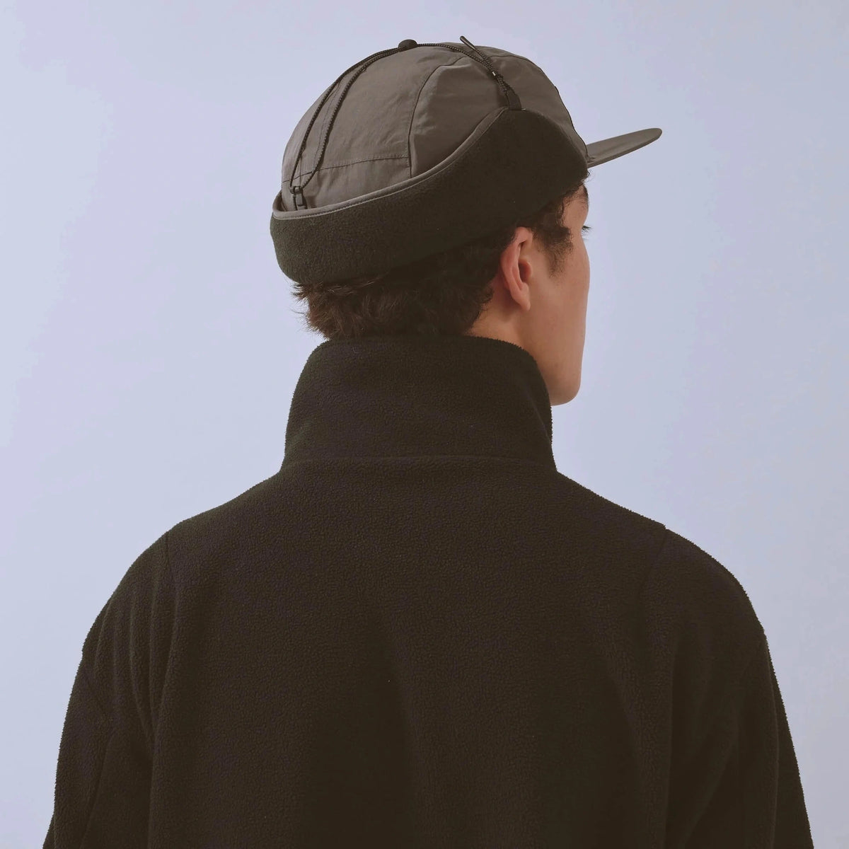 Vaga Padded Hiker Cap in grey – worn, rear view with ear flaps up